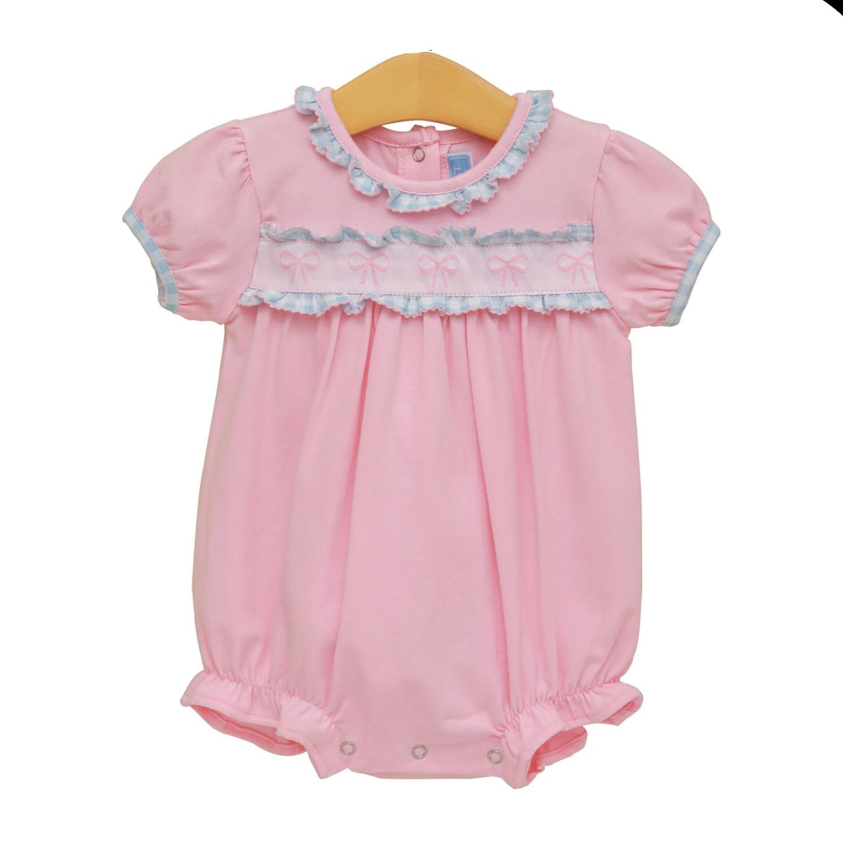 Pink baby romper with lace details on a white background